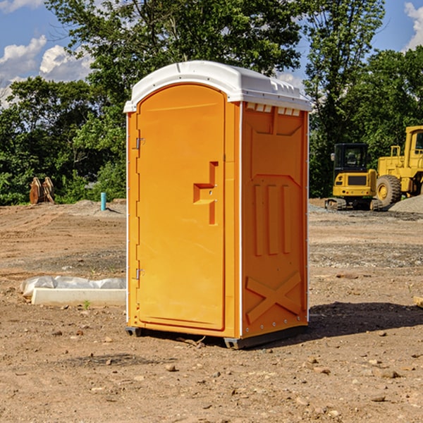 what is the cost difference between standard and deluxe portable toilet rentals in Woodstock